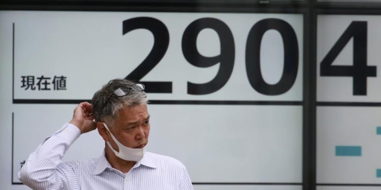 Asian markets lower after Wall Street recovers to new high