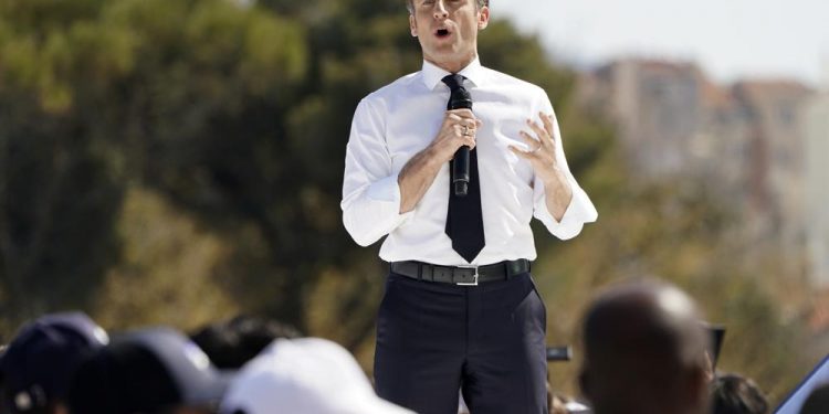 Macron courts Marseille voters; climate activists in Paris