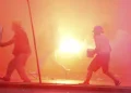 Peru’s protest ‘deactivators’ run toward tear gas to stop it