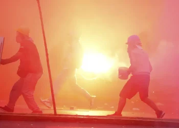 Peru’s protest ‘deactivators’ run toward tear gas to stop it